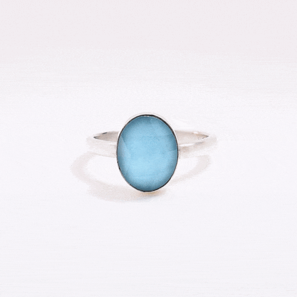 Handmade sterling silver ring with doublet made of natural crystal quartz and turquoise gemstones in an oval shape. The doublet consists of two layers of stones. The upper stone is faceted crystal quartz and the stone at the bottom is turquoise. Buy online shop.