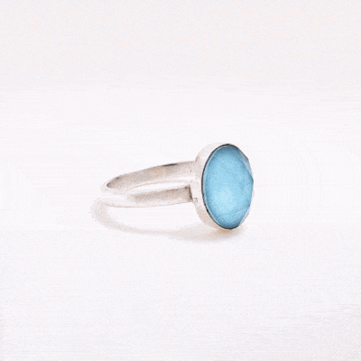 Handmade sterling silver ring with doublet made of natural crystal quartz and turquoise gemstones in an oval shape. The doublet consists of two layers of stones. The upper stone is faceted crystal quartz and the stone at the bottom is turquoise. Buy online shop.