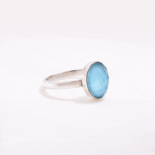 Handmade sterling silver ring with doublet made of natural crystal quartz and turquoise gemstones in an oval shape. The doublet consists of two layers of stones. The upper stone is faceted crystal quartz and the stone at the bottom is turquoise. Buy online shop.