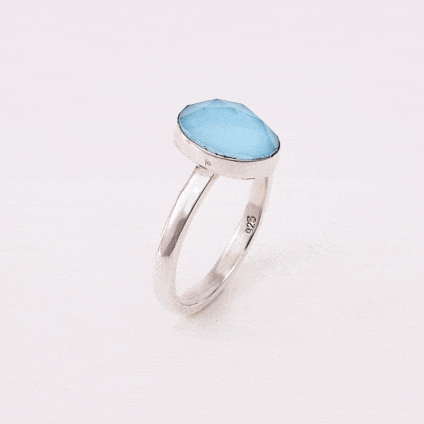 Handmade sterling silver ring with doublet made of natural crystal quartz and turquoise gemstones in an oval shape. The doublet consists of two layers of stones. The upper stone is faceted crystal quartz and the stone at the bottom is turquoise. Buy online shop.