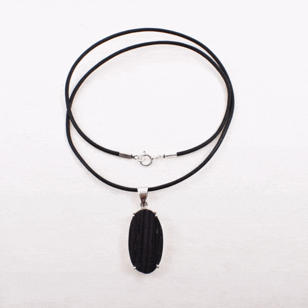 Handmade pendant made of sterling silver and natural, oval shaped black tourmaline gemstone, threaded on a black leather with sterling silver clasp.