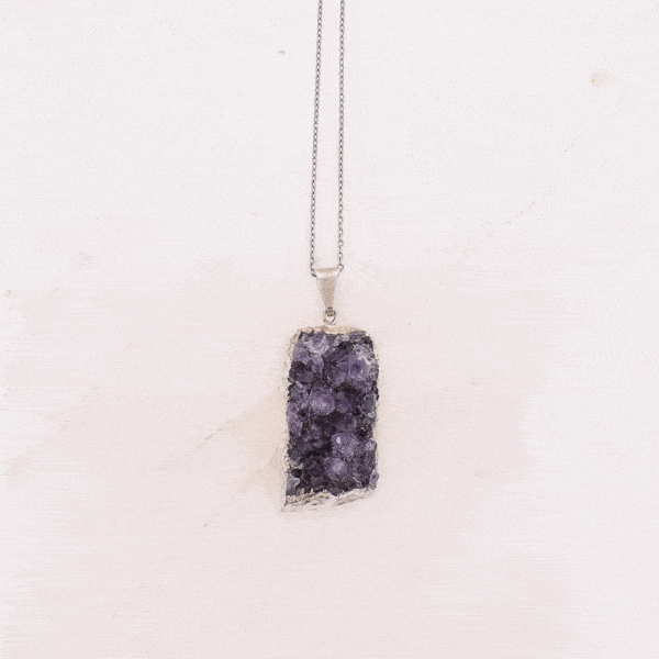 Pendant made of hypoallergenic silver plated metal and natural amethyst gemstone in a raw form. The pendant is threaded on a sterling silver chain with adjustable length. Buy online shop.