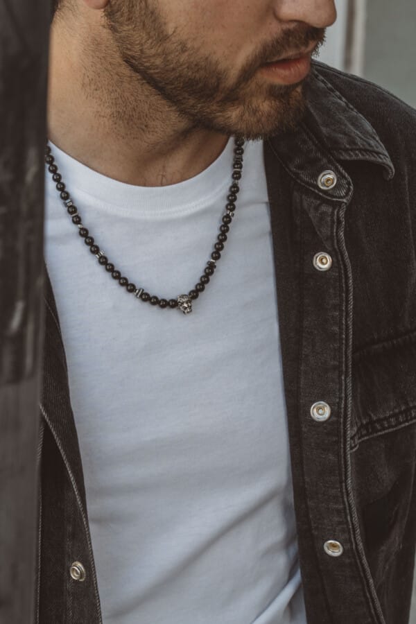 Handmade necklace made of natural black tourmaline and hematite gemstones with a silver lion's head in the center. The necklace has a clasp and decorative elements made of silver sterling. Buy online shop.