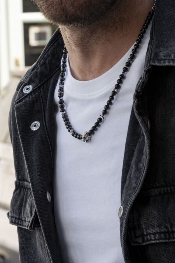 Handmade necklace made of natural black tourmaline and hematite gemstones with a silver lion's head in the center. The necklace has a clasp and decorative elements made of silver sterling. Buy online shop.