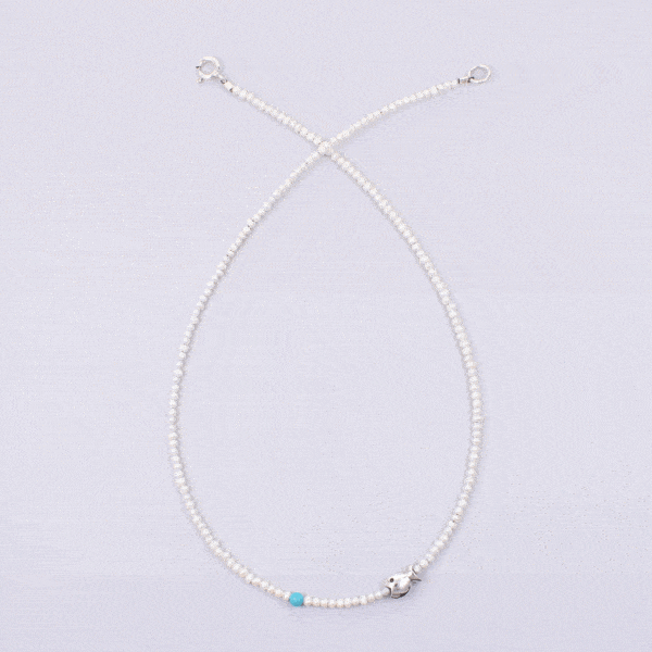 Handmade natural pearl necklace with spherical turquoise stone and a sterling silver fish.