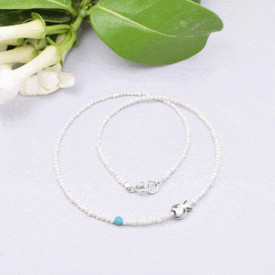 Handmade natural pearl necklace with spherical turquoise stone and a sterling silver fish.