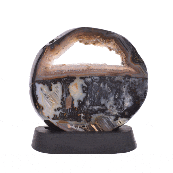 Polished 21.5cm slice of natural agate gemstone with crystal quartz, placed on a black, wooden base.  Buy online shop.