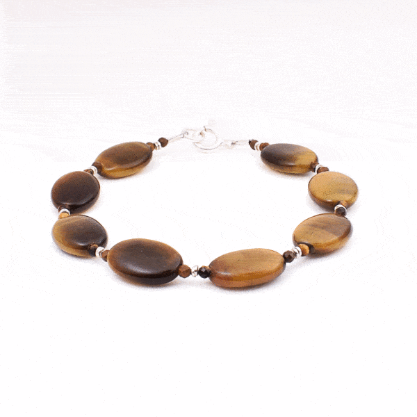 Handmade bracelet made of natural tiger's eye gemstones in an oval and spherical shape, with decorative sterling silver elements. Buy online shop.