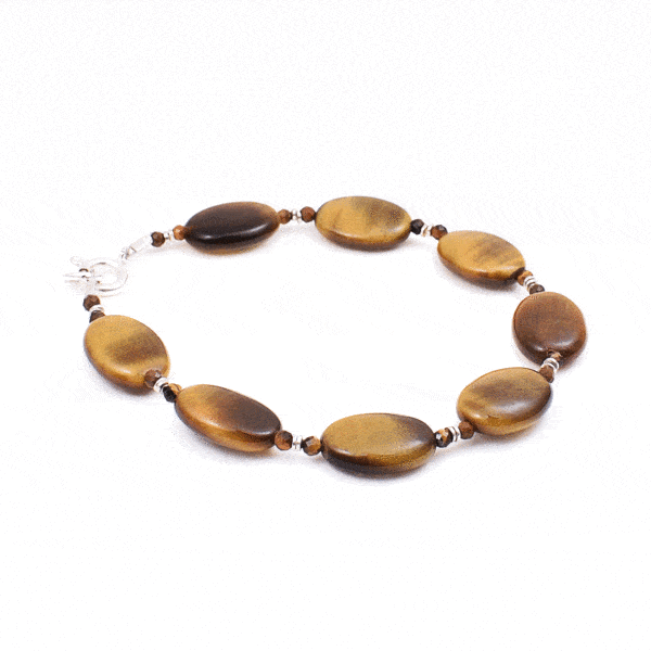 Handmade bracelet made of natural tiger's eye gemstones in an oval and spherical shape, with decorative sterling silver elements. Buy online shop.