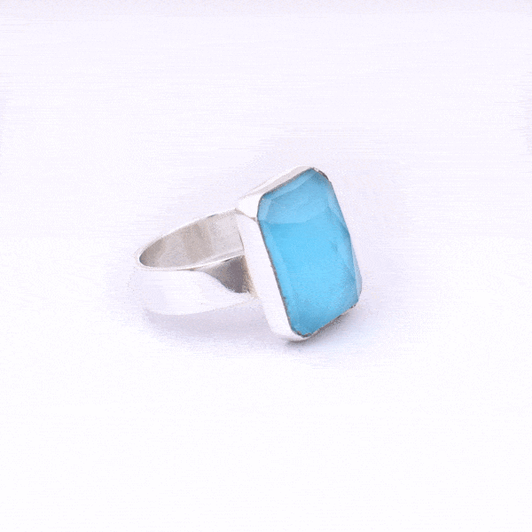 Handmade sterling silver ring with doublet made of natural crystal quartz and turquoise gemstones in a parallelogram shape. The doublet consists of two layers of stones. The upper stone is faceted crystal quartz and the stone at the bottom is turquoise. Buy online shop.