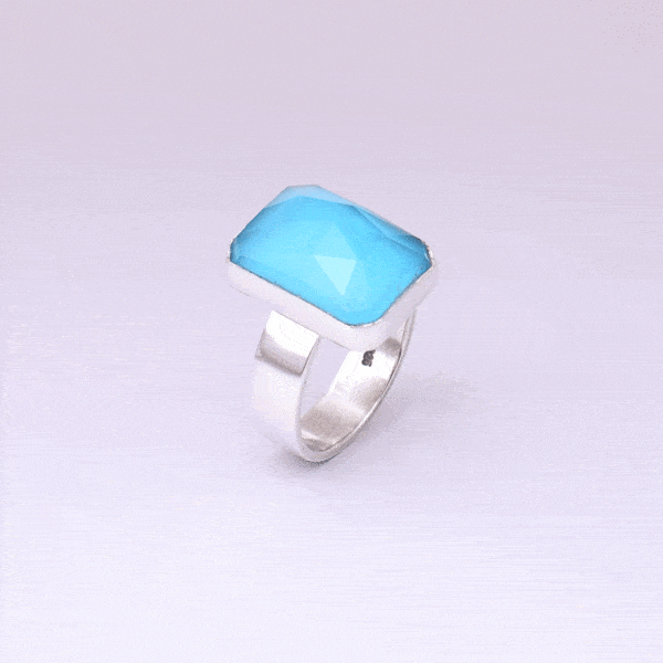 Handmade sterling silver ring with doublet made of natural crystal quartz and turquoise gemstones in a parallelogram shape. The doublet consists of two layers of stones. The upper stone is faceted crystal quartz and the stone at the bottom is turquoise. Buy online shop.