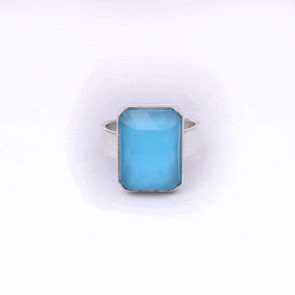 Handmade sterling silver ring with doublet made of natural crystal quartz and turquoise gemstones in a parallelogram shape. The doublet consists of two layers of stones. The upper stone is faceted crystal quartz and the stone at the bottom is turquoise. Buy online shop.