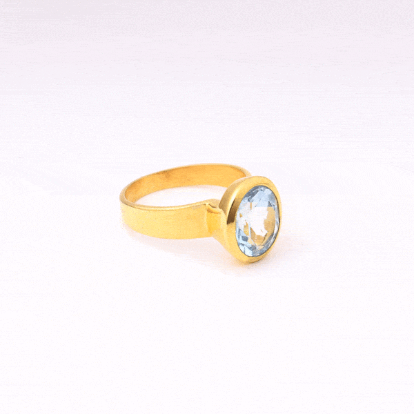 Handmade oval shaped ring made of natural blue topaz stone and gold plated silver 925.