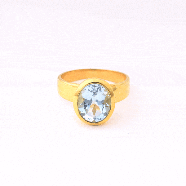 Handmade oval shaped ring made of natural blue topaz stone and gold plated silver 925.