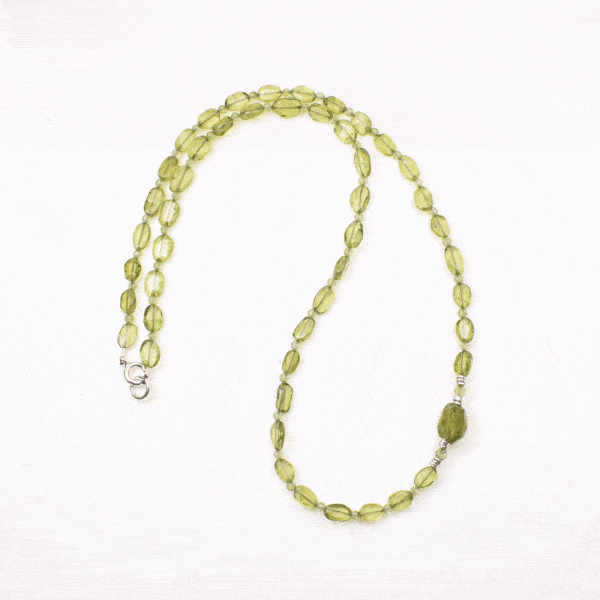 Handmade necklace made of natural, oval and spherical shaped peridot gemstones, decorated with sterling silver elements. Buy online shop.