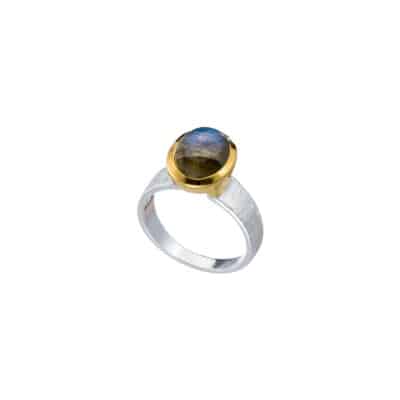 Handmade sterling silver ring with natural, oval shaped labradorite gemstone. The ring has textured band and gold plated bezel. 