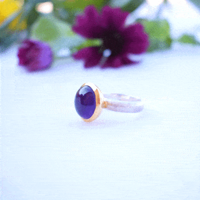 Handmade ring made of sterling silver with natural amethyst stone in a round shape. The ring features a textured band and gold-plated bezel setting